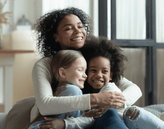 Mother hugging children